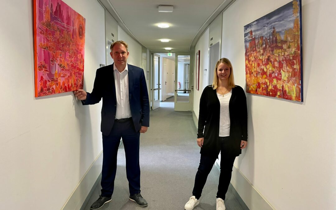 Die CDU-Landtagsabgeordneten Vanessa Odermatt und Jochen Klenner mit ihren Saharabildern von Gundhild Tillmanns im Fraktionsflur des Düsseldorfer Landtages